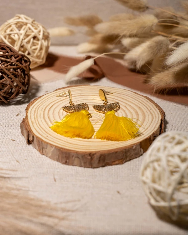 Kolczyki boho z żółtym chwostem i złotym wachlarzem to lekka biżuteria handmade, która zachwyca słoneczną kolorystyką, kobiecą elegancją i letnim stylem.